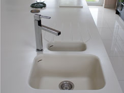 A close up image of the corian worktop with the 1.5 bowl moulded sink